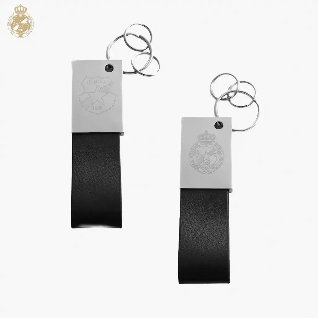 Two black leather keychains with metal tags on a white background