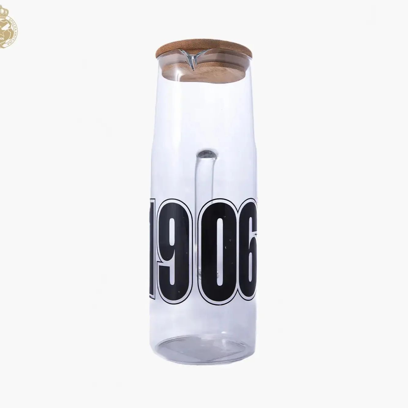 Clear glass carafe with wooden lid and '1906' branding on a white background